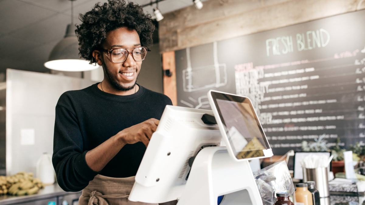 A merchant working at the point of sale